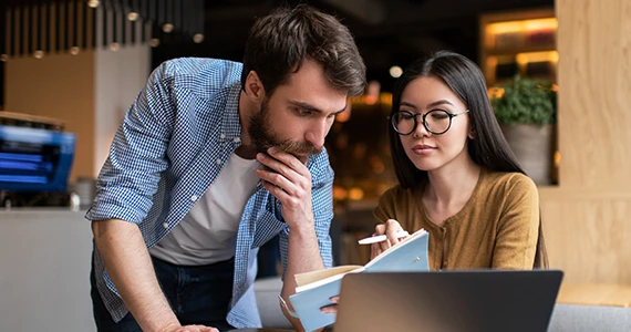 people looking at laptop